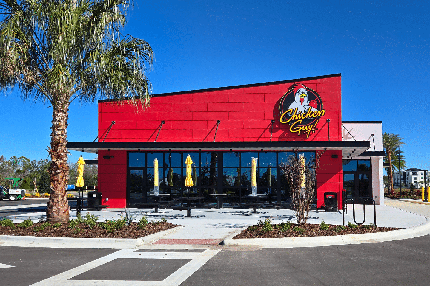 A red and yellow building with the Chicken Guy! logo.