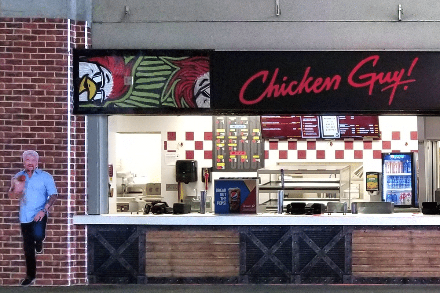 The storefront of Chicken Guy! FedEx Field with Guy Fieri in the background